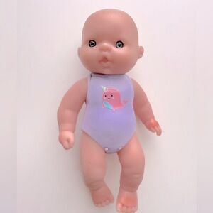 Mini Baby Doll Wearing A Narwhal Onesie